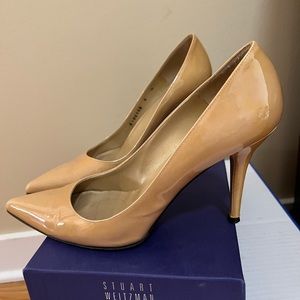 Nude patent leather Stuart Weizmann heels.